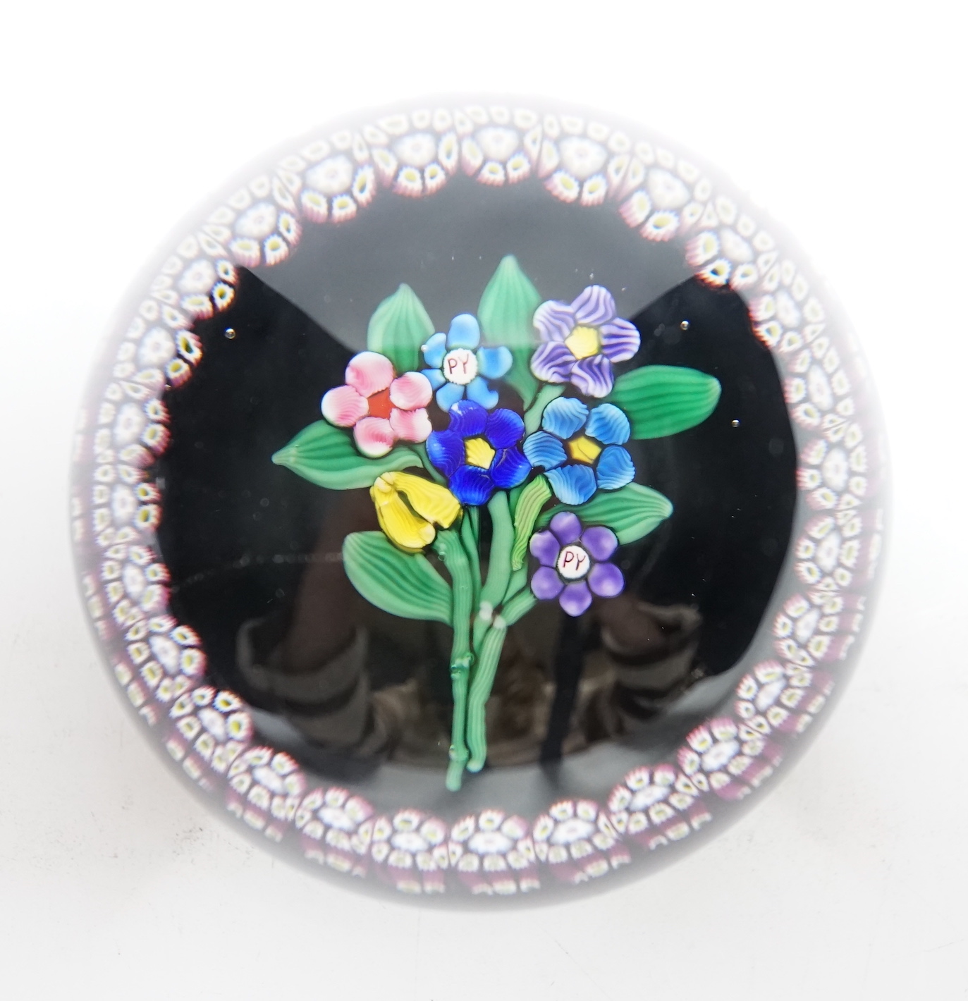 A rare Paul Ysart ‘small flower bouquet’ paperweight with double ‘PY’ cane, Caithness period, CG paper label to base, 7.5cm
